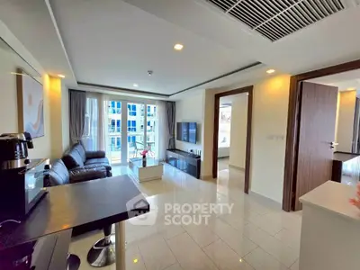 Modern living room with sleek furniture and large windows in a contemporary apartment.