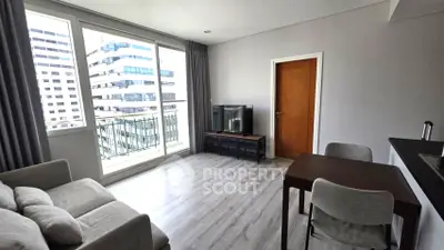 Modern living room with balcony view in high-rise apartment