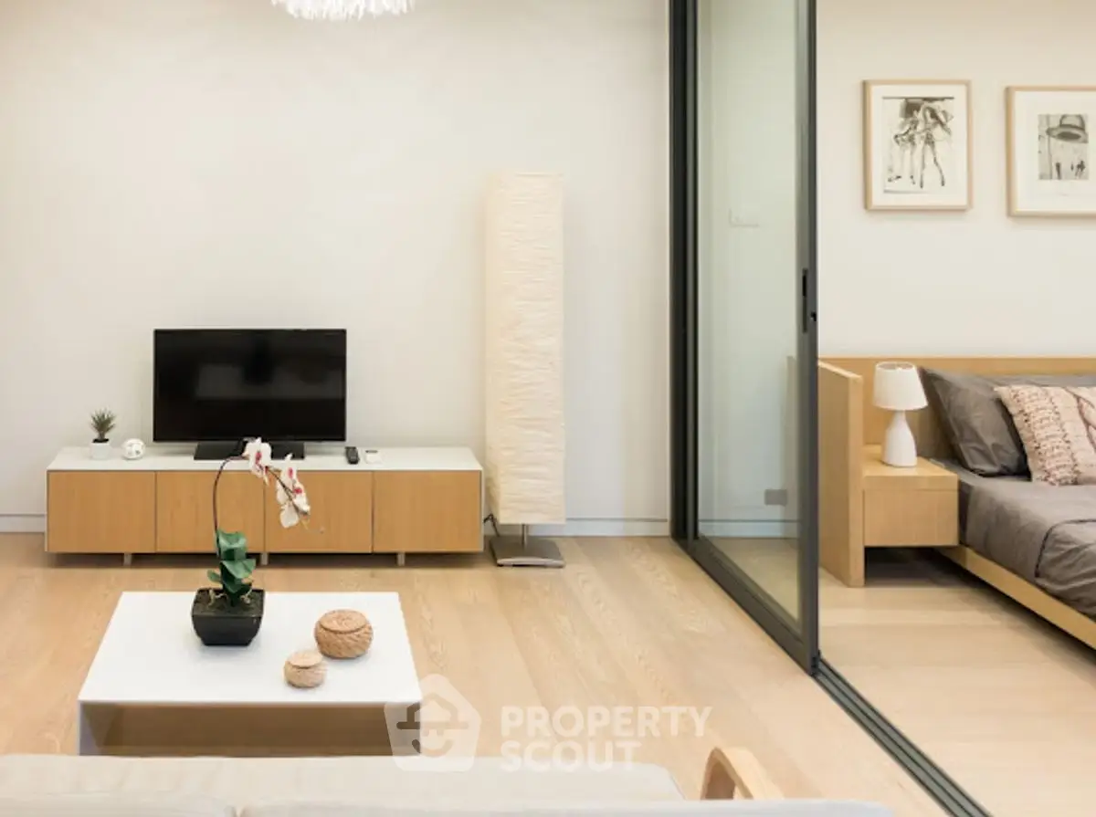 Modern living room with sleek design and cozy bedroom view