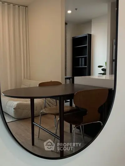 Modern dining area with stylish table and chairs in a cozy apartment setting.