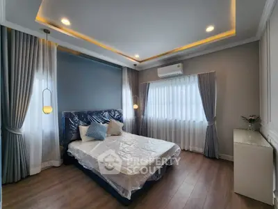 Modern bedroom with stylish lighting and elegant curtains