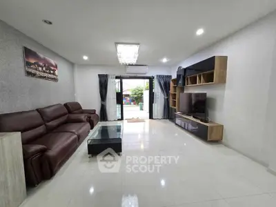 Spacious modern living room with sleek furniture and large windows for natural light.