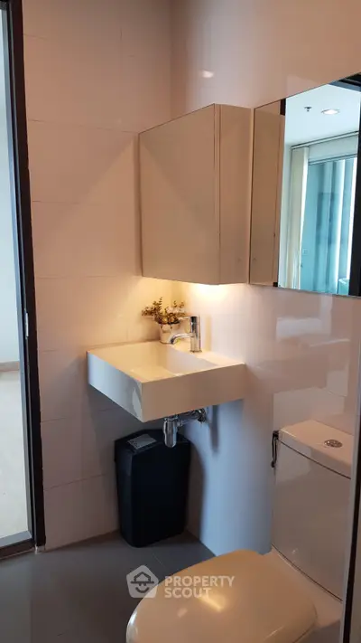Modern bathroom with sleek fixtures and elegant lighting in a contemporary apartment.