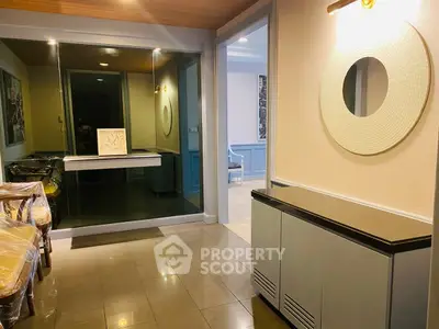 Stylish modern interior with elegant decor and mirrored accents in a spacious living area.