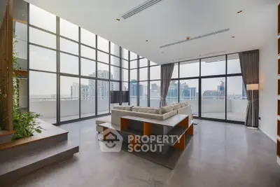 Spacious modern living room with panoramic city views and stylish decor