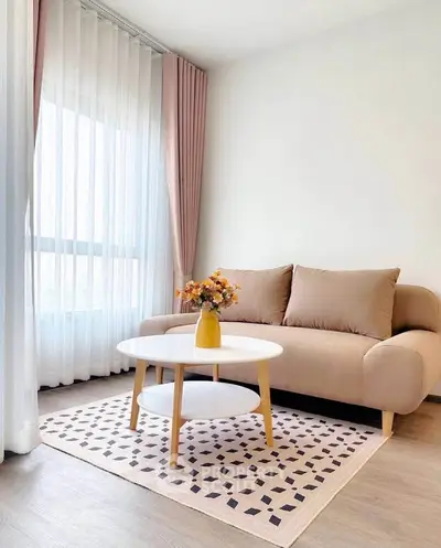 Chic living room with cozy beige sofa and stylish coffee table, perfect for modern urban living.