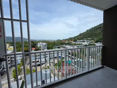 Stunning balcony view overlooking lush hills and urban landscape