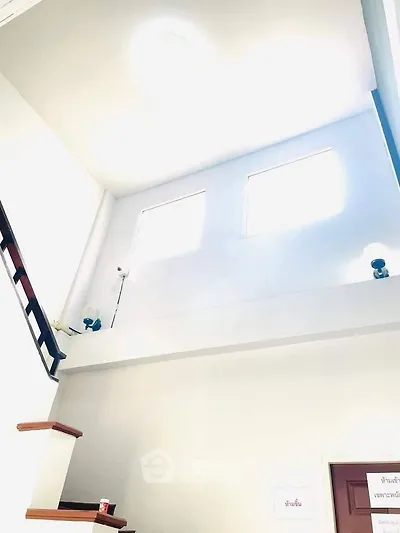 Bright interior stairway with high ceiling and natural light