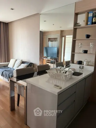 Modern open-plan living room with sleek kitchen island and cozy seating area.