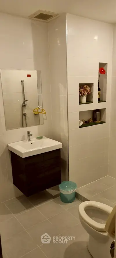 Modern bathroom with sleek fixtures and built-in shelving