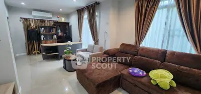 Spacious living room with plush brown sofa and elegant curtains, perfect for relaxation.