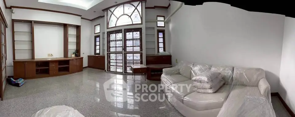 Spacious living room with elegant furniture and large windows for natural light.