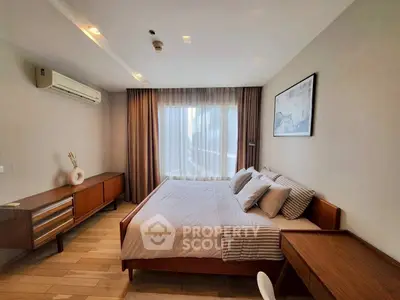 Modern bedroom with stylish wooden furniture and large window