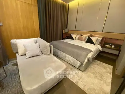 Luxurious bedroom with elegant decor and cozy seating area, perfect for relaxation and comfort.