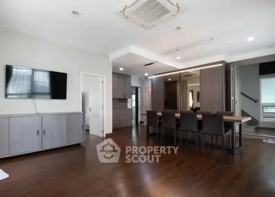 Spacious modern living room with wooden flooring and sleek furniture