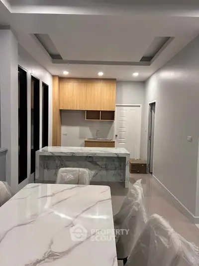 Modern kitchen with marble countertops and sleek wooden cabinetry