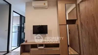 Modern living room with wall-mounted TV and air conditioning unit