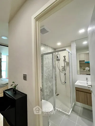 Modern bathroom with glass shower and sleek fixtures in a contemporary apartment