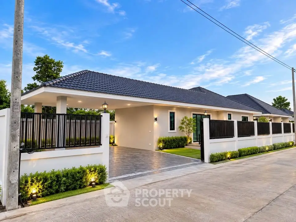 Modern single-story home with sleek design and spacious driveway in a serene neighborhood.