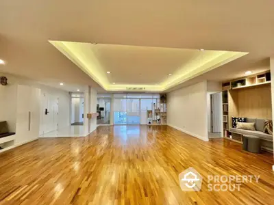 Spacious modern living room with wooden flooring and recessed lighting