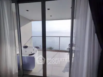 Luxurious balcony with stunning ocean view and private jacuzzi.