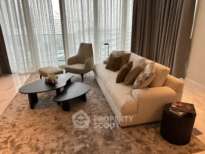 Luxurious living room with elegant furniture and floor-to-ceiling windows offering a stunning city view.