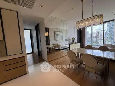 Luxurious dining area with elegant chandelier and city view in modern apartment