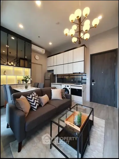 Modern living room with stylish decor, open kitchen layout, and elegant lighting in a cozy apartment.