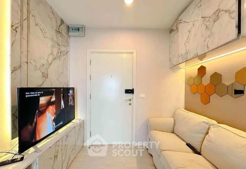 Modern living room with marble accents and cozy sofa in stylish apartment.