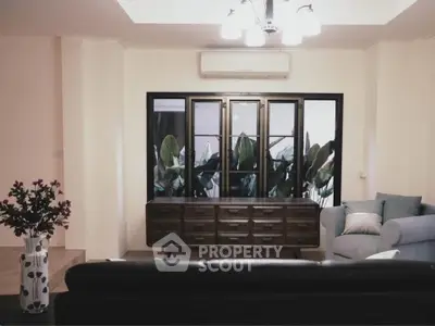 Stylish living room with modern furniture and large window view