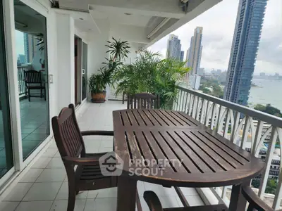 Spacious balcony with wooden furniture and stunning city view