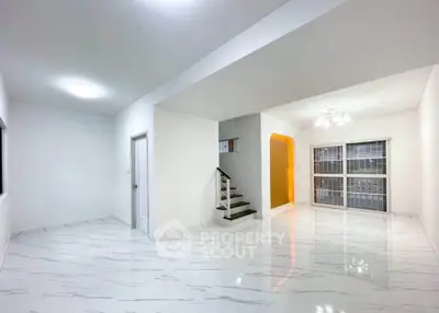 Spacious modern living room with sleek marble flooring and bright lighting