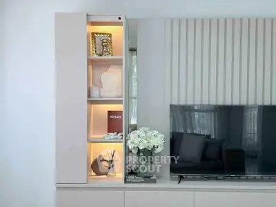 Modern living room with sleek TV unit and elegant decor accents