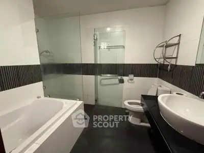 Modern bathroom with bathtub and glass shower enclosure