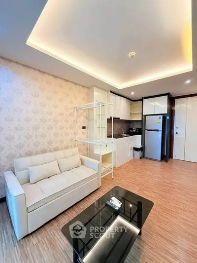 Modern living room with stylish open kitchen and elegant lighting