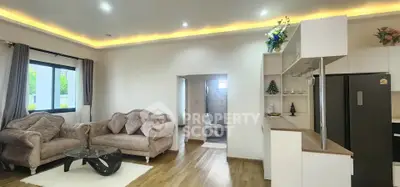 Spacious living room with elegant decor and modern kitchen in open layout