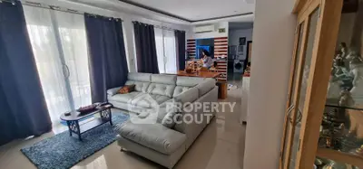 Spacious living room with modern decor and large windows for natural light.