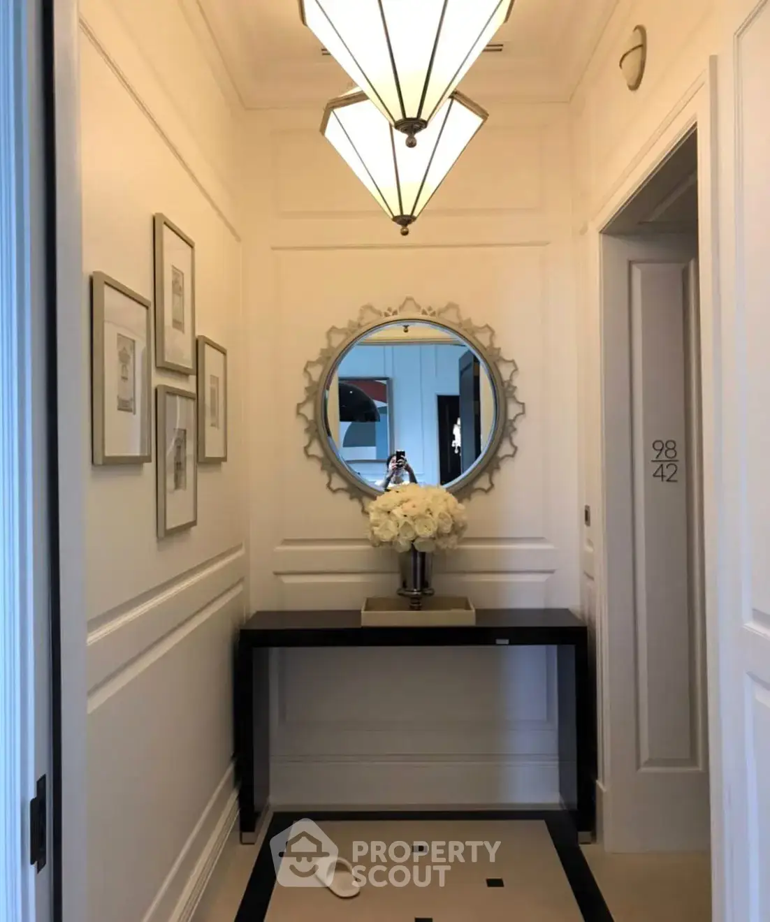 Elegant hallway with modern lighting and decorative mirror