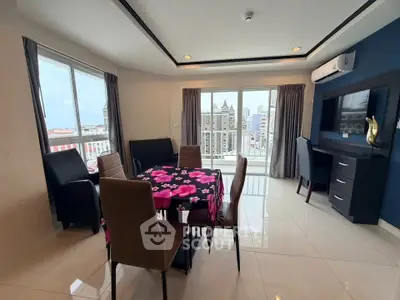 Spacious living room with modern dining area and city view