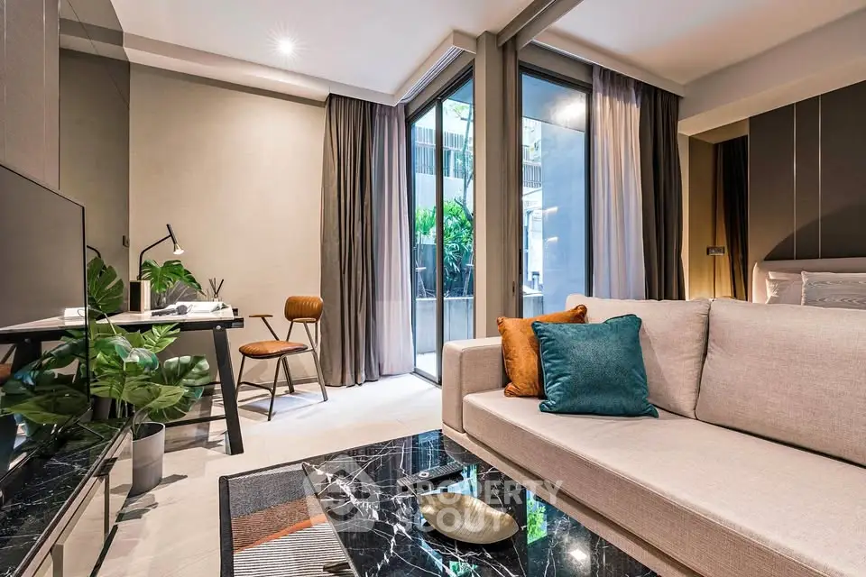 Modern living room with stylish decor and large windows opening to a lush garden view.