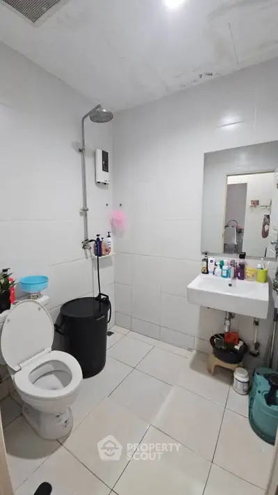 Modern bathroom with shower, toilet, and sink in a minimalist design.