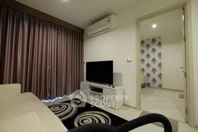 Modern living room with TV, air conditioning, and stylish decor