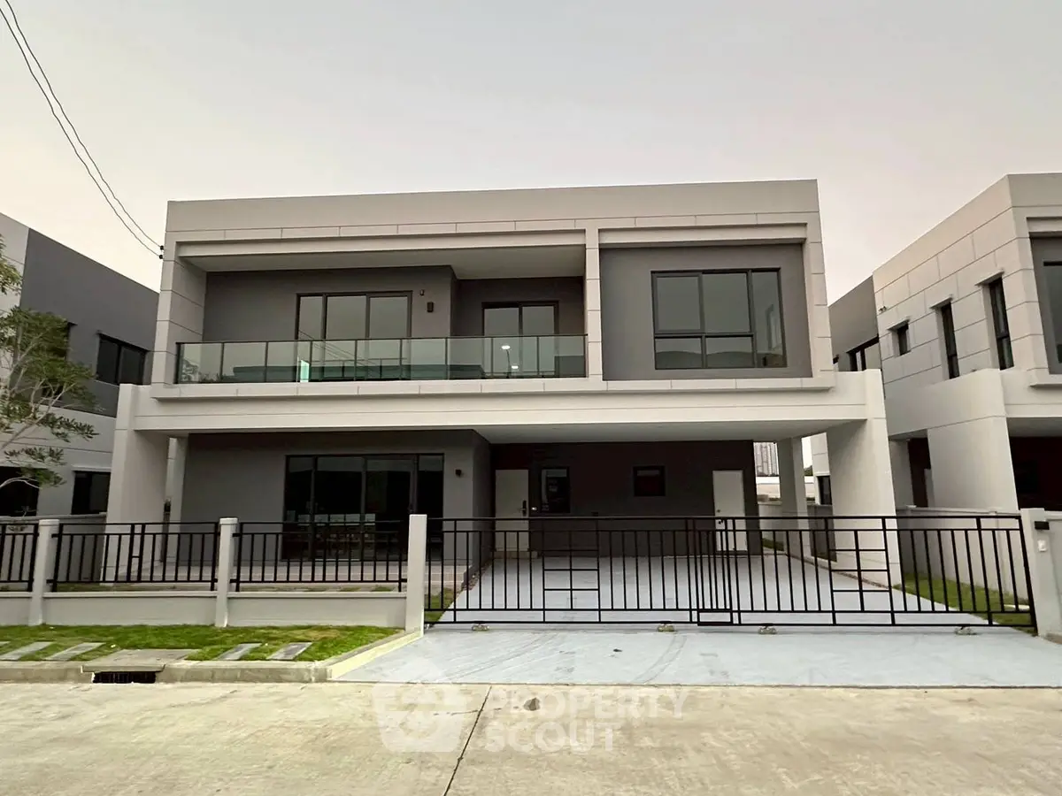 Modern two-story house with spacious balcony and sleek design