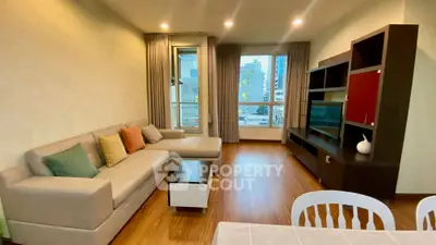 Modern living room with cozy sofa and city view window in stylish apartment.