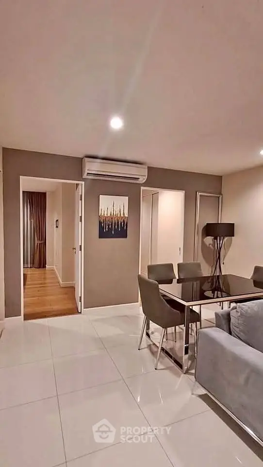 Modern living room with sleek dining area and stylish decor in a contemporary apartment.