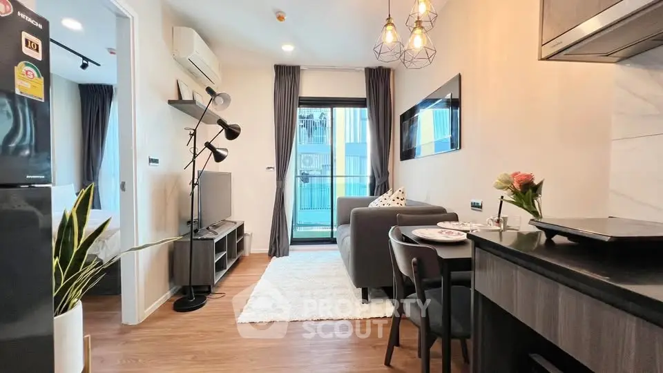 Modern living room with stylish decor and open kitchen layout in a cozy apartment.