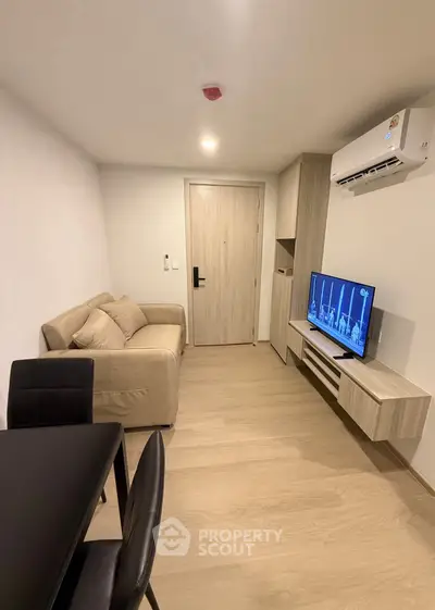 Modern living room with cozy sofa and wall-mounted TV in stylish apartment