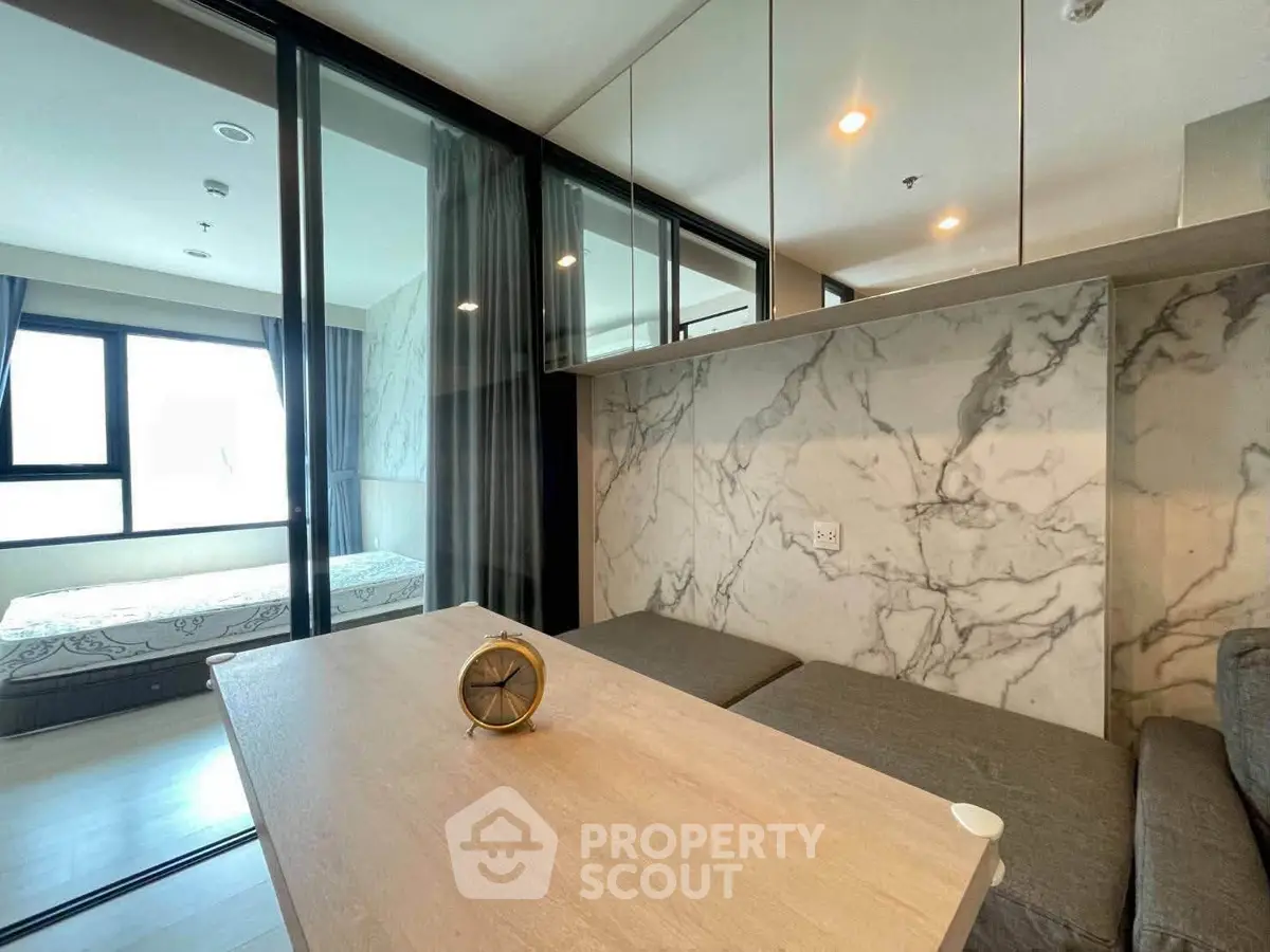 Modern apartment interior with marble accents and cozy furnishings