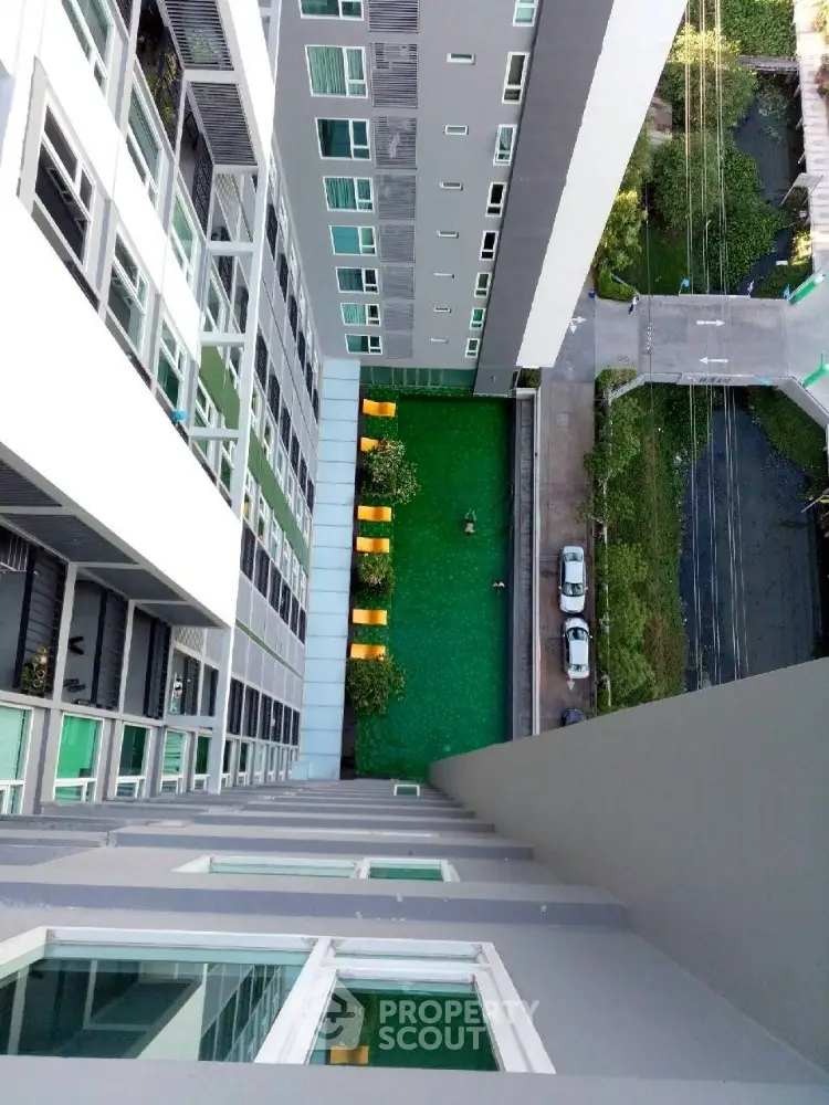 High-rise building with green courtyard view from above
