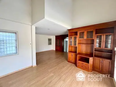 Spacious living room with elegant wooden cabinetry and natural light